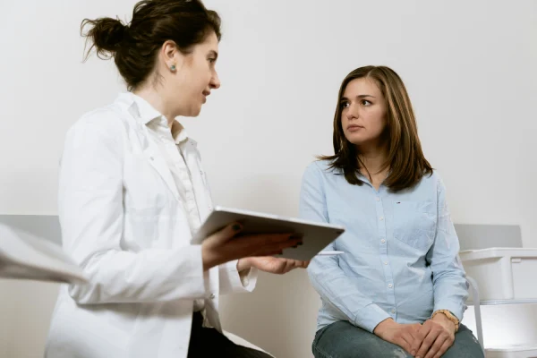 a woman having a consultation to a doctor