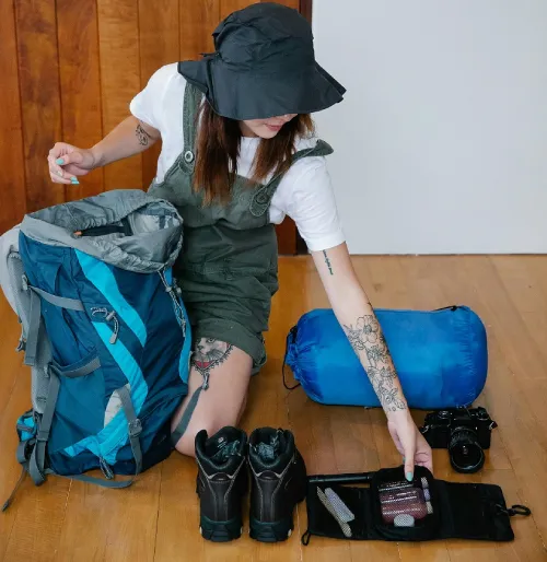 a woman kneading on the floor, preparing for a trip