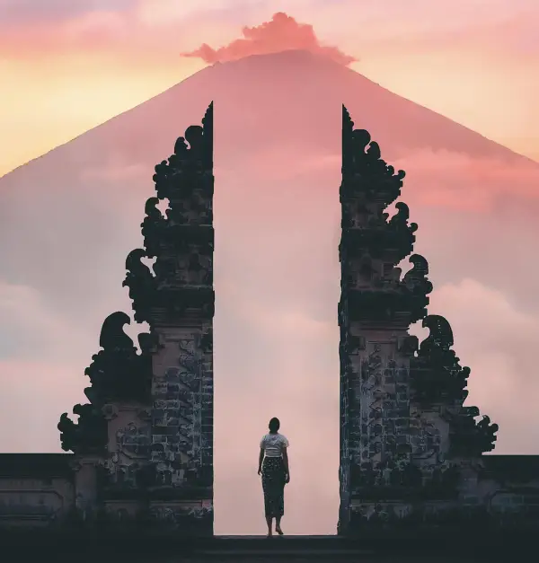 Photo of Person Standing on a Famous Temple in Bali Indonesia - cheap tropical places to visit