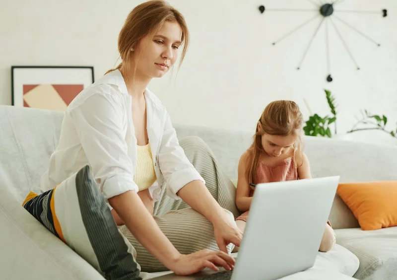 a pregnant woman sitting trying to work from home